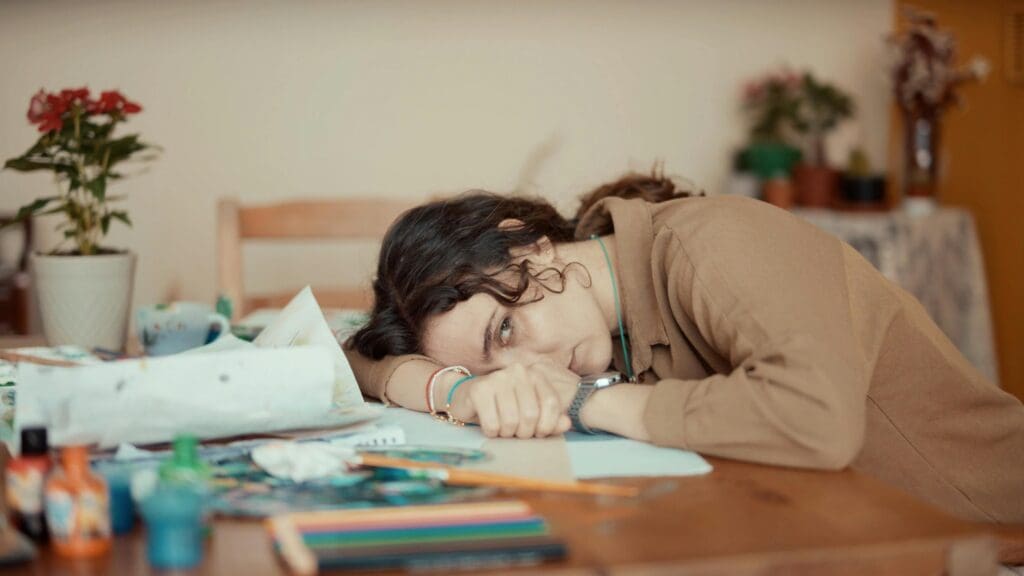 Woman feeling off and emotionally drained, wondering about signs her body is trying to tell her something